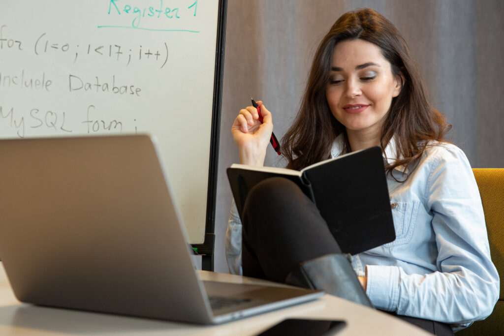 woman with notepad and pen in her hands